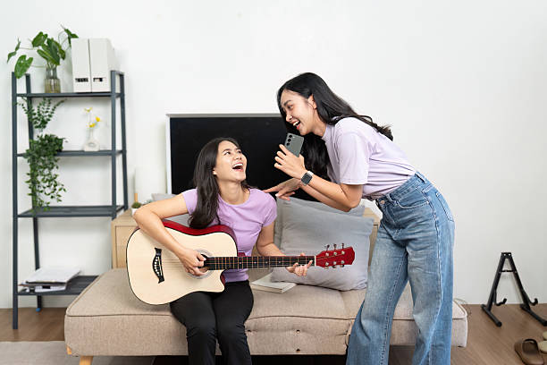 istock Musical Fun. Two friends enjoying a lively jam session at home. 2220894140