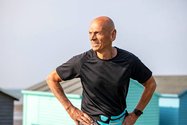 Portrait of a man posing against a dark background