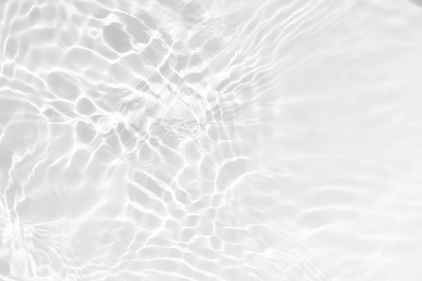 istock Blue water with ripples on the surface. Defocus blurred transparent blue colored clear calm water surface texture with splashes and bubbles. Water waves with shining pattern texture background. 2220898954