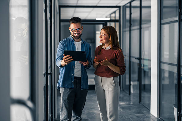 istock Two Professionals Engaging in a Discussion in a Modern Office Corridor 2220899311