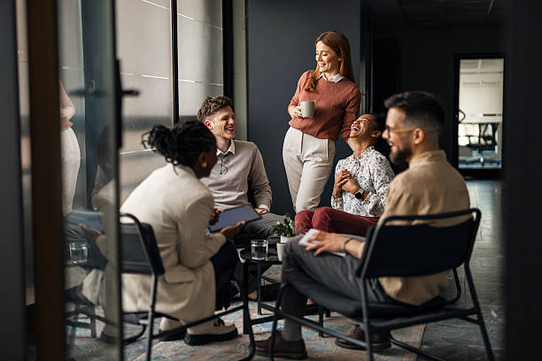 istock Group of Colleagues Sharing a Laugh During an Informal Office Meeting 2220899502