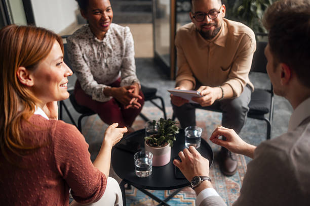 istock Small Group Engaging In Casual Business Conversations Around A Table 2220899532