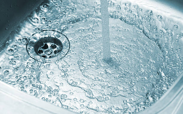 istock Running water in stainless kitchen sink 2220900178