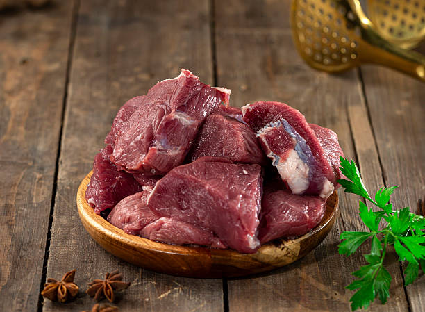 istock Fresh red veal cuts on wooden surface, ready for cooking. 2220905496