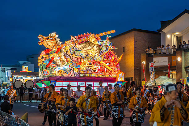 Goshogawara, Aomori, Japan - August 7 2024 : Participants pull a massive nebuta float during the Goshogawara Tachineputa Festival, an energetic night time street parade.