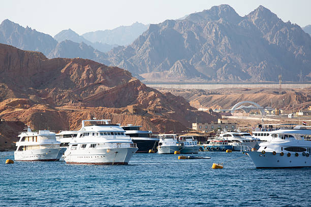 Yachts in the harbour, desert and mountains in the background