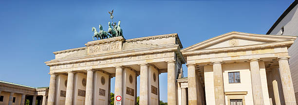istock Side-angle view of the Brandenburg Gate in Berlin, Germany, with supporting columns and neoclassical details on a sunny day 2220908144