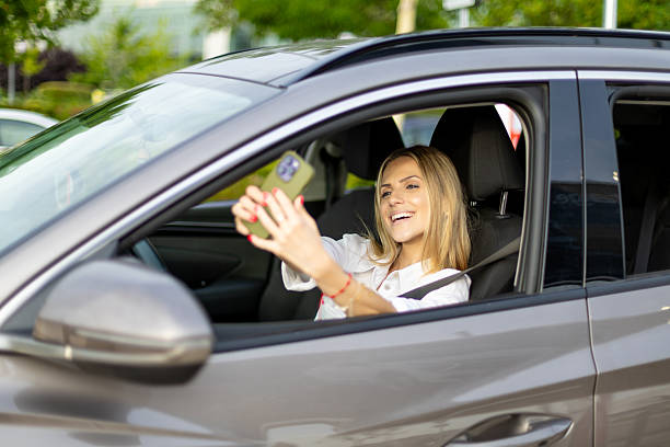 istock Happy businesswoman taking selfie while driving car 2220910432
