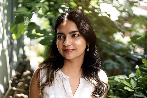 istock Indian ethnicity female portrait outdoors in natural light surrounded by greenery 2220910923