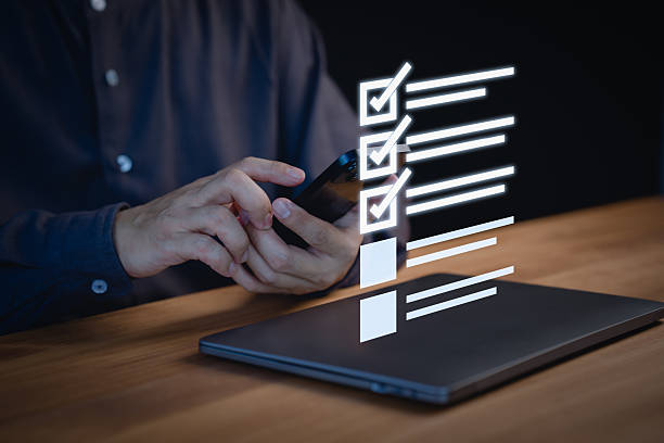 istock Person using a smartphone to check items off a digital checklist, productivity, and organization. Concept emphasizes the use of technology for staying organized and completing tasks efficiently. 2220911528