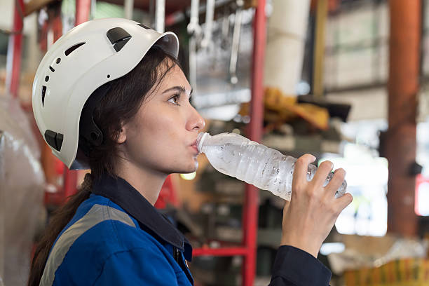 istock Worker drinking water in break time in factory 2220913540