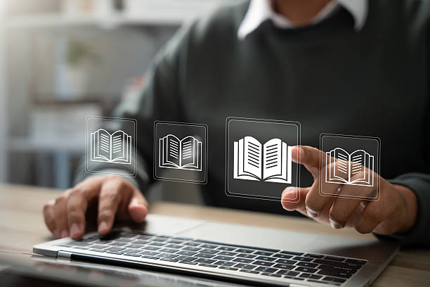 istock E-library and E-learning Concept, Person using laptop with virtual E-Book icons for online knowledge Base, Digital library, Access electronic books on Internet. Course education. Webinar technology. 2220921462