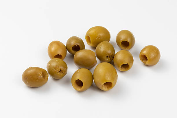 istock Pickled green olives on a white background. Marinated olives in close-up. 2220922332