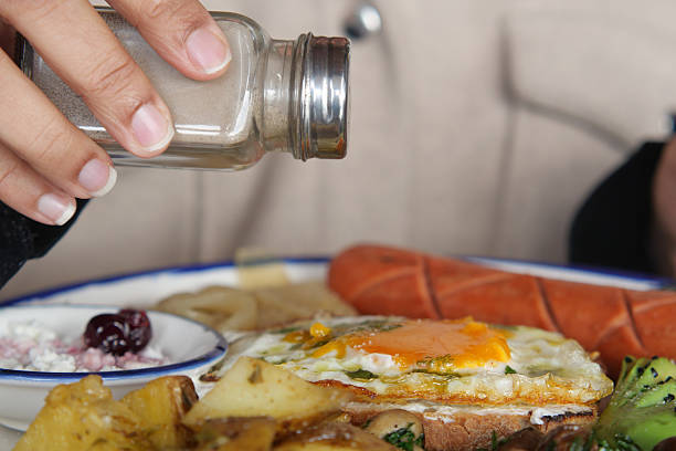 istock Adding Salt to a Delicious Breakfast Plate for Enhanced Flavor 2220923442
