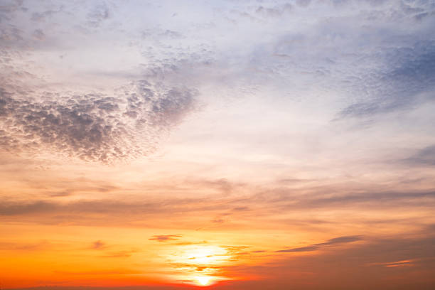 Sky,Beautiful sunset view, luxury soft gradient orange gold clouds and sunlight on the blue dramatic sky perfect for the background, morning, evening,Twilight, climate change,horizontal sunset photo