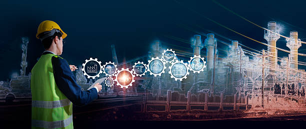 istock Smart industrial engineer working with futuristic technology interface, industry 4.0 concept with automation, digital transformation, supply chain, production and energy icons in factory background 2220925380