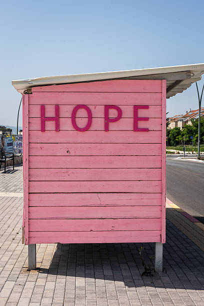 A pink, wooden bus shelter in Israel delivers a message of hope. stock photo