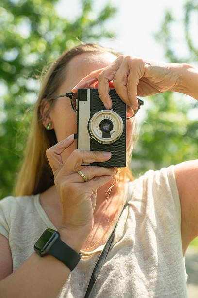 Woman making photos with film camera