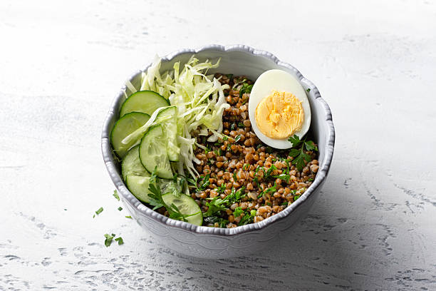 istock Nutritious Buckwheat Bowl with Fresh Cucumber, Cabbage, and Egg 2220932865
