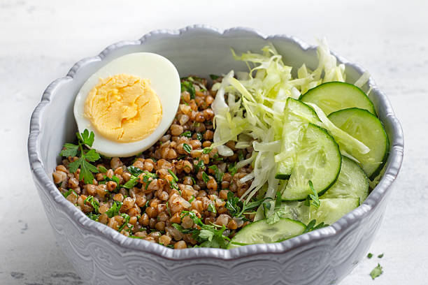 istock Nutritious Buckwheat Bowl with Fresh Cucumber, Cabbage, and Egg 2220932915