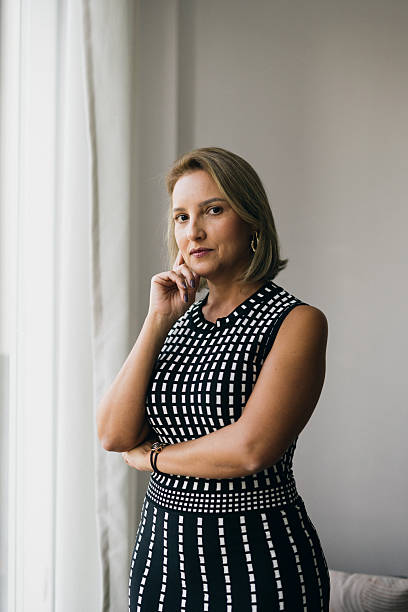 istock Female executive standing by the window 2220936222