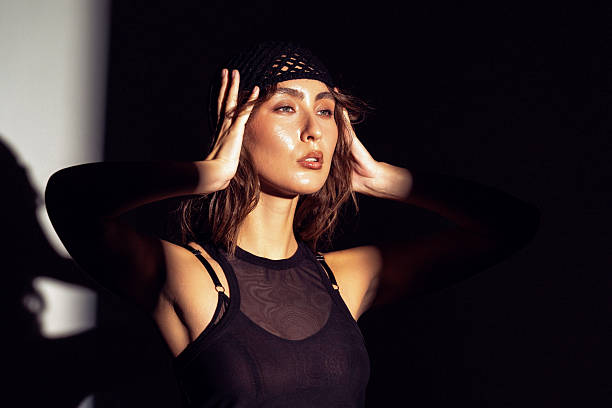 istock Stunning Asian woman striking a pose in dramatic lighting at an artistic indoor space 2220937795