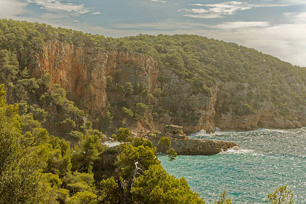 istock Wild mediterranean coastline with impressive cliffs and forest seen from the coastal trail near Bandol 2220940953