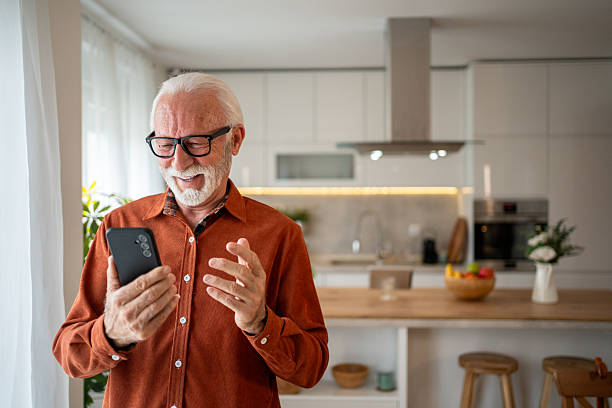istock Happy senior man using smartphone at home, enjoying modern technology 2220950819