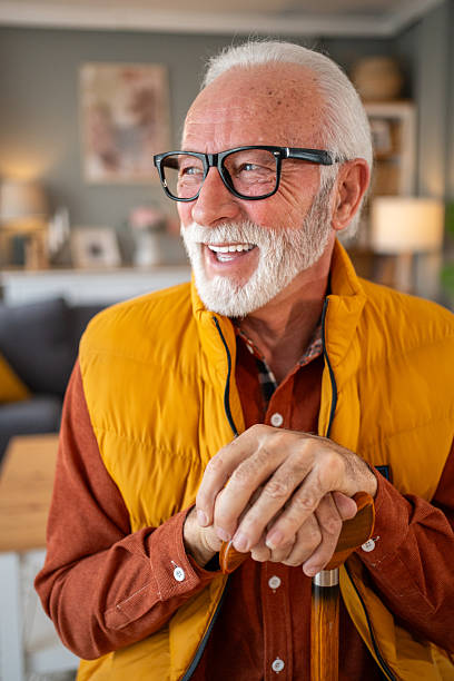 istock Happy senior man smiling and leaning on walking cane at home 2220951377