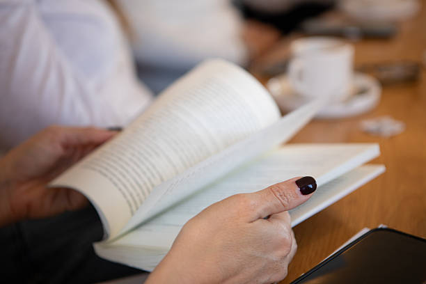 istock Close-up of a woman's hands with a book 2220953450