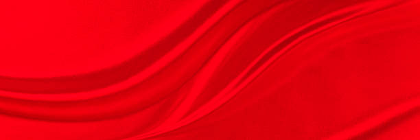 istock Black red satin dark fabric texture luxurious shiny that is abstract silk cloth background with patterns soft waves blur beautiful. 2220954281