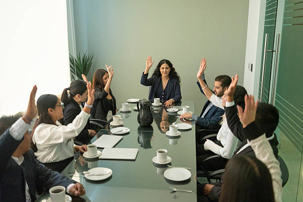 istock businessmen in boardroom in voting 2220955172