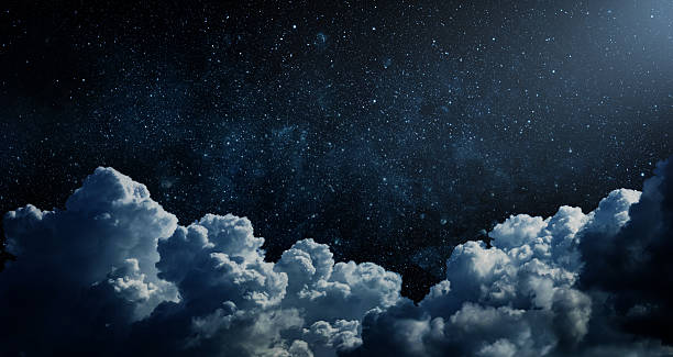 istock Starry night sky with clouds.. Panorama. Universe filled with stars, nebula and galaxy,. Elements of this image furnished by NASA 2220958403