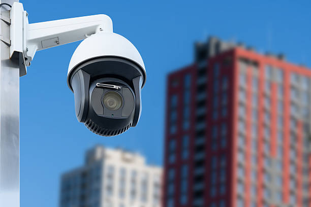 istock CCTV camera or surveillance operating. Background of broken houses. 2220958829