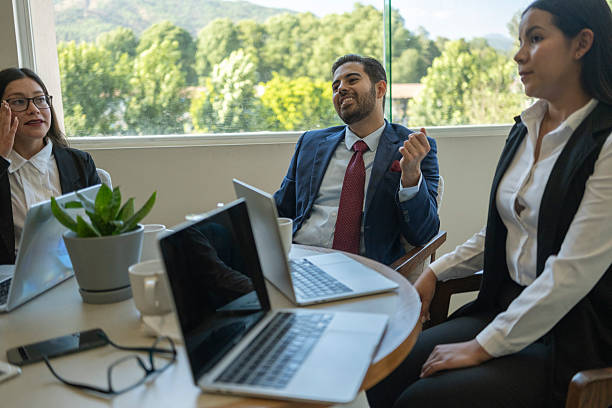 istock people in an executive meeting with computers and tablets in a work environment 2220961122