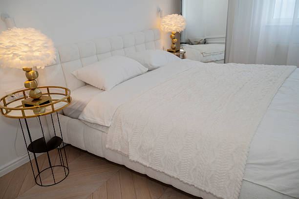 istock interior of a bright bedroom, a white headboard, a white blanket and bed linen 2220963588