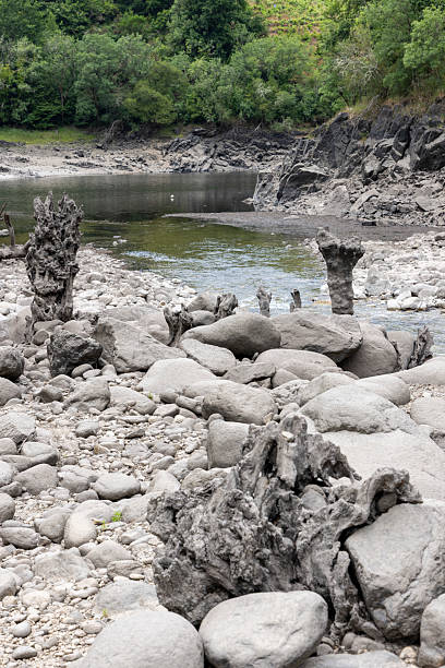 istock Ash-Covered Riverbank with Volcanic Rock Formations 2220963610