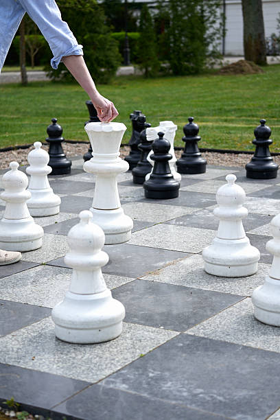 istock The female hand moves large pieces on a large chessboard 2220964021