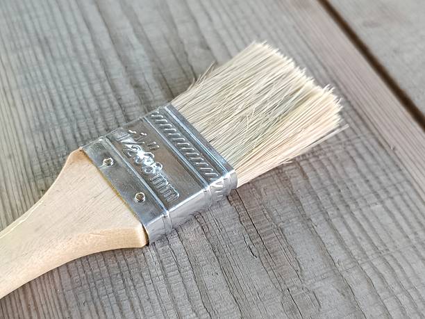 istock A paint brush lies on a wooden surface 2220966964