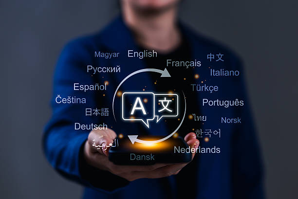 istock Multilingual Language Translation Technology Concept. A person holding smartphone with translation icons and global languages, representing modern multilingual translation technology. AI translator, 2220969149