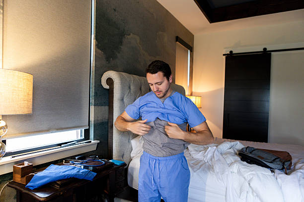 istock Male Doctor Getting Ready for Work in Bedroom 2220970756