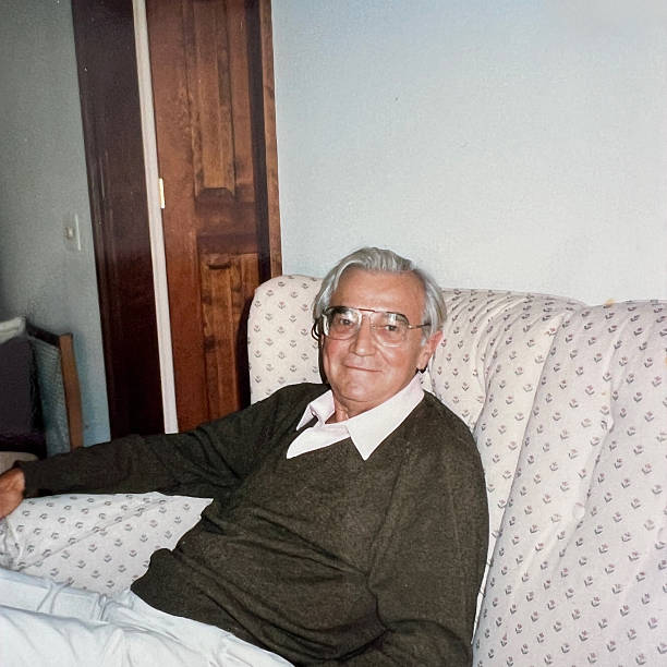 Senior man sitting on a sofa in the 1980s