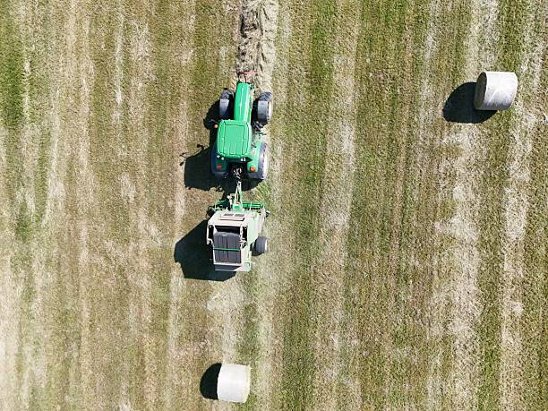 istock A tractor with a baler in the field, shot with a drone 2220975144