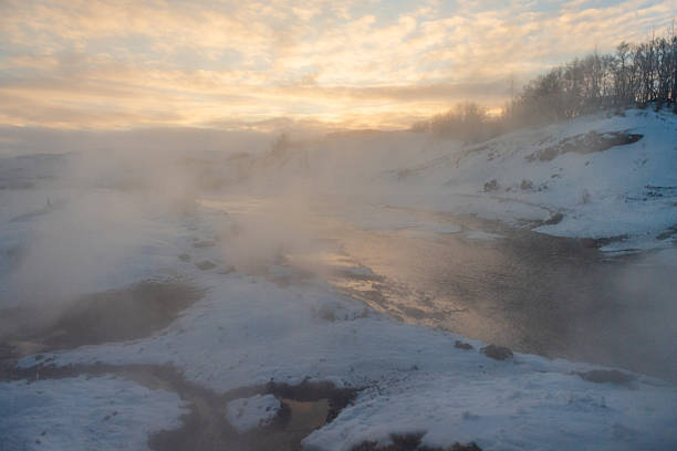 Outdoor scene showing active Geysers steaming near the Secret lagoon area in Southern Iceland.