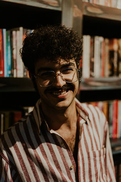 istock Young librarian smiling in a bookstore or library 2220975830