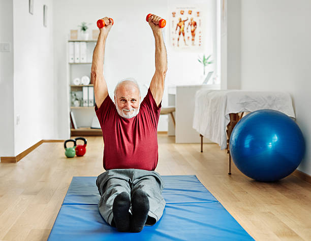 doctor senior care exercise physical therapy exercising help retirement  physiotherapy strech band clinic therapist elderly man