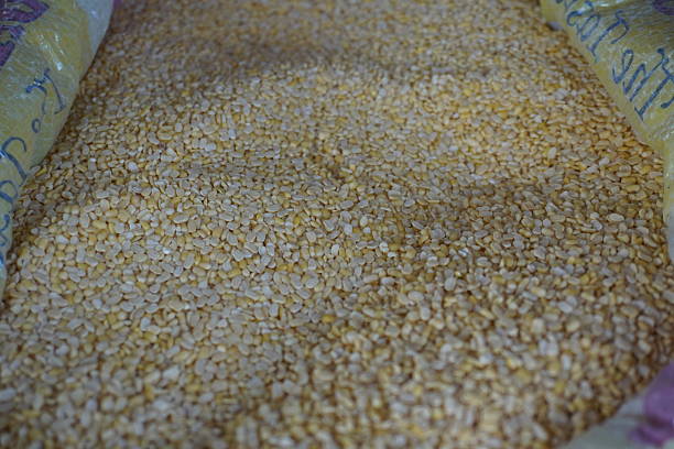 A pile of yellow lentils, specifically Moong Dal