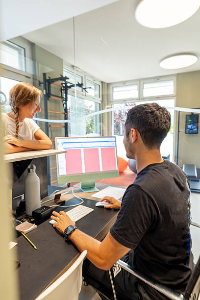 istock Physical therapist assisting patient with exercise plan in clinic 2220978709