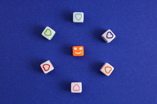 Cube with a happy face surrounded by colorful hearts