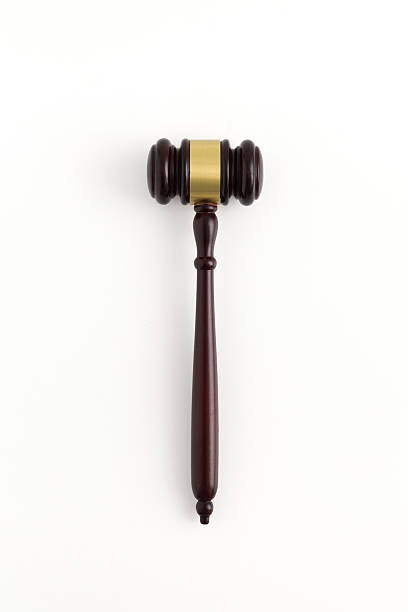 istock Wooden judge gavel top view isolated on white 2220983554
